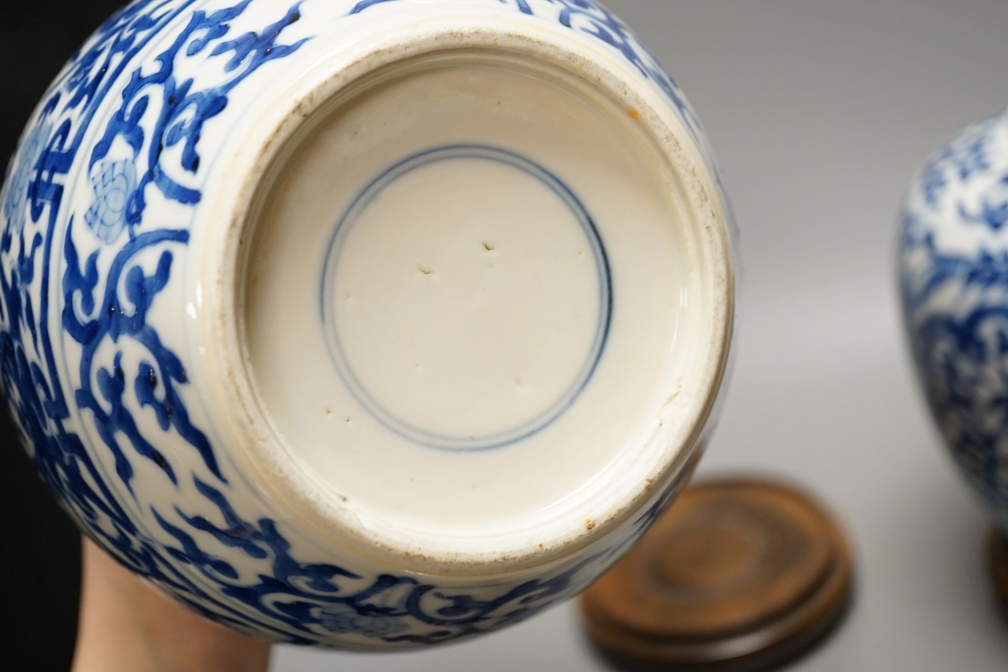 A pair of Chinese blue and white ginger jars and covers, 22cm, On stands